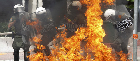 Riot policeman are engulfed in flames as they are hit with a molotov cocktail near the Greek parliament in Athens during a nationwide strike in Greece, May 5, 2010. Greece braced for a day of demonstrations during a nationwide strike by civil servants protesting the announcement of draconian austeristy measures. REUTERS/Pascal Rossignol (GREECE)