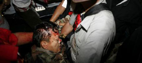 Major General Khattiya Sawasdipol is carried to an ambulance after being shot in the head behind the barricades at a fortified camp in Bangkok's shopping district May 13, 2010. Sawasdipol, the chief military advisor of Thailand's "red shirt" anti-government protesters, was injured in the head, after an explosion and bursts of automatic gunfire were heard near Bangkok's business district on Thursday night. REUTERS/Steve Pace (THAILAND - Tags: CIVIL UNREST POLITICS IMAGES OF THE DAY)