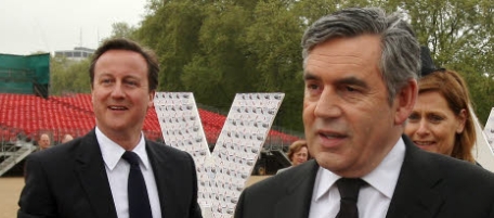 Prime Minster Gordon Brown prepares to add a message of thanks to a tribute to British servicemen, watched by his wife Sarah and Conservative Party leader David Cameron, at Horse Guards Parade, Westminster, London Saturday May 8, 2010. The event recalled the moment that Second World War hostilities in Europe ended on May 8 1945. (AP Photo/Dominic Lipinski, Pool)