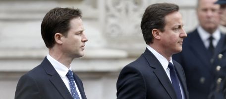 Britain's Conservative Party leader David Cameron, right, and Liberal Democrat party leader Nick Clegg, left, hold their wreaths as they arrive at a service to commemorate the 65th anniversary of the end of World War II in Europe, at the Cenotaph in London, Saturday, May 8, 2010. (AP Photo/Alastair Grant)