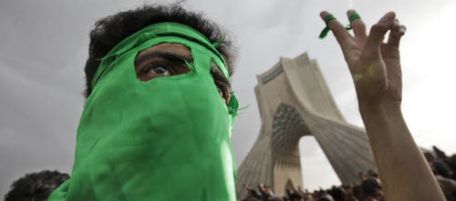 FILE - In this Monday, June 15, 2009 file photo, a demonstrator wearing a mask in the opposition party's color of green due to fears of being identified, turns out to protest the result of the election at a mass rally in Azadi (Freedom) square in Tehran, Iran. Iranian authorities have slowed Internet connections to a crawl or choked them off completely before expected student protests Monday, to deny the opposition a vital means of communication. (AP Photo/Ben Curtis, File)
