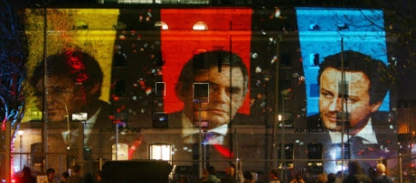 Images of the three main party leaders are projected onto the building where filming is taking place of Britain's second televised election debate in Bristol, England, Thursday, April 22, 2010. The debate is broadcast live and could be a game-changer for the upcoming General Election on May 6, with candidates dueling over foreign affairs. Images are: Conservative leader David Cameron, right, Liberal Democrat Party leader Nick Clegg, left, and Labour leader Prime Minister Gordon Brown, right. (AP Photo / Johnny Green, pa) ** UNITED KINGDOM OUT NO SALES NO ARCHIVE **