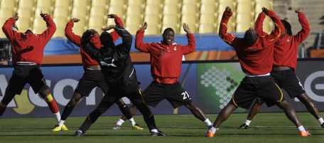Ghana's Kwadwo Asamoah, center, stretches with teammates during a Ghana national soccer team pre-match training session at Royal Bafokeng Stadium in Rustenburg, South Africa, Friday, June 18, 2010. Ghana is preparing to face Australia Saturday in their World Cup Group D soccer match. (AP Photo/Rebecca Blackwell)