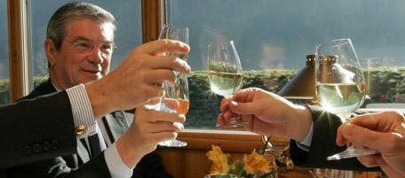 From left, France's Transportation Minister Dominique Perben and Italy's Transportation Minister Pietro Lunardi clink glasses with Swiss Transportation Minister Moritz Leuenberger in the palace car of a Rhaetian Railway train in Chur, Switzerland, Monday, Nov 14, 2005. The transport ministers of the Alpine countries Switzerland, Germany, Austria, France and Italy are heading to Sedrun in the canton of Grisons to discuss questions of transport, security and mobility. (AP Photo/Keystone, Alessandro Della Bella)