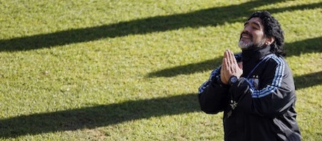 Argentina's soccer team coach Diego Maradona kneels while speaking to a journalist after a practice in Pretoria, South Africa, Tuesday, June 15, 2010. Argentina plays in the Group B of the World Cup. (AP Photo/Ricardo Mazalan)