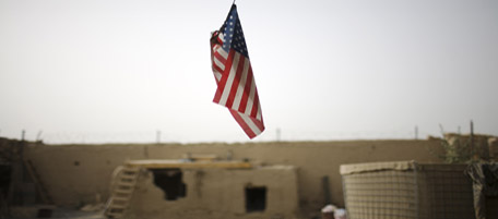 A U.S. flag hangs from the roof of COP Nolen, in the volatile Arghandab Valley in Kandahar, Afghanistan, Saturday, July 24, 2010. (AP Photo/Rodrigo Abd)