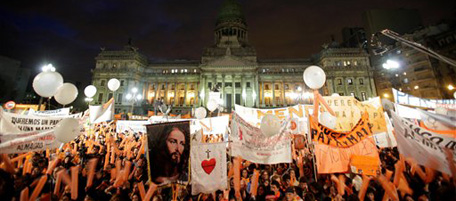 Members of Catholic groups protest outside Argentina's Congress against a same sex marriage bill in Buenos Aires, Tuesday, July 13, 2010. On Wednesday, senators are expected to vote over the bill which would make Argentina become the first Latin American country to legalize same sex marriage. (AP Photo/ Natacha Pisarenko)