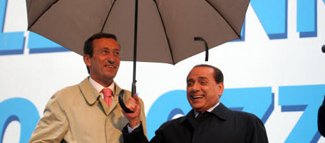 Italian Premier-elect Silvio Berlusconi, right, and right-wing ally Gianfranco Fini, laugh under an umbrella at a rally for fellow party mayoral candidate Gianni Alemanno, in Rome, Thursday April 24, 2008. Right-wing Berlusconi ally Alemanno faces former two-time center-left Rome mayor Francesco Rutelli in a runoff for Rome's mayorship on April 27-28. (AP Photo/Sandro Pace)