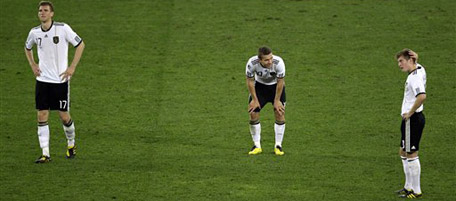 Germany players from left, Per Mertesacker, Lukas Podolski, and Toni Kroos react at the end of the World Cup semifinal soccer match between Germany and Spain at the stadium in Durban, South Africa, Wednesday, July 7, 2010. Spain won 1-0. (AP Photo/Hassan Ammar)