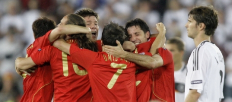 Spanish players celebrate as Germany's Arne Friedrich, right, passes by after the Euro 2008 final between Germany and Spain in the Ernst-Happel stadium in Vienna, Austria, Sunday, July 29, 2008, the last day of the European Soccer Championships in Austria and Switzerland. Spain defeated Germany 1-0. (AP Photo/Ivan Sekretarev)
