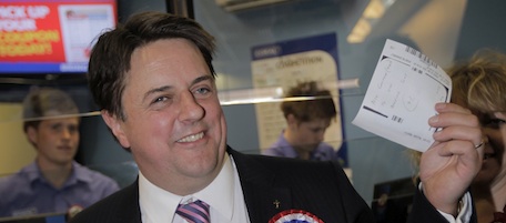 Nick Griffin, right, the leader of the British National Party and a member of the European Parliament, poses for the photographers at a betting shop after he bet 20 british pounds (some 30 US dollars) with odds 4: 1 that he will be elected at the local constituency during a campaign tour in Dagenham Heathway in east London, Saturday April 10, 2010. Britain goes to the polls in a general election on May 6, 2010. (AP Photo/Lefteris Pitarakis)