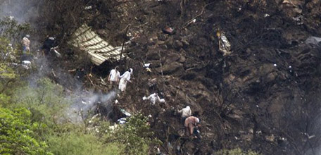 Pakistani rescue workers look for survivors at the site of a passenger plane crash in mountains of Islamabad, Pakistan on Wednesday, July 28, 2010. The passenger jet carrying 152 people crashed into the hills surrounding Pakistan's capital amid rain Wednesday, officials said. According to a Pakistani government official over two dozen bodies have been recovered from the site, but many more were feared dead, while several passengers have been rescued. (AP Photo/B.K.Bangash)