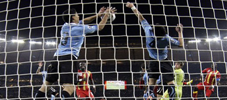 Uruguay's Luis Suarez, left, stops the ball with his hands to give away a penalty kick during the World Cup quarterfinal soccer match between Uruguay and Ghana at Soccer City in Johannesburg, South Africa, Friday, July 2, 2010. (AP Photo/Ivan Sekretarev)