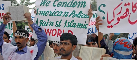 Supporters of a Pakistani Islamic student group hold Muslims holy book Quran as they chant slogans during a rally to condemn the ongoing Israeli strikes against Lebanon and Palestinian territories, Tuesday, Aug. 8, 2006 in Lahore, Pakistan. Pakistan's president urged the United Nations secretary-general to help stop the Israeli "aggression" in Lebanon, saying a delay in a cease-fire would worsen the situation in Lebanon. (AP Photo/K M Chaudhry)