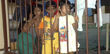 Children of Sri Lankan asylum seekers part of 100 ethnic Tamils who were caught in Indonesian waters in October of last year, stand behind bars at the Indonesian immigration detention center in Tanjungpinang, Riau islands, Indonesia, Thursday, April 29, 2010. Indonesia is a major launching post for Afghans, Iranian, Iraqis and Sri Lankans seeking refuge in Australia. (AP Photo/Syaifullah)