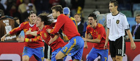 Spain's Carles Puyol, second from left, celebrates with fellow team members after scoring a goal during the World Cup semifinal soccer match between Germany and Spain at the stadium in Durban, South Africa, Wednesday, July 7, 2010. (AP Photo/Daniel Ochoa de Olza)