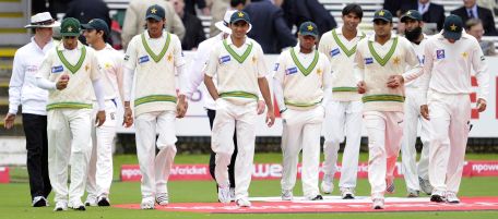 In this photo taken on Friday, Aug. 27, 2010, Pakistani players walk to the pitch during the second day of the fourth cricket test match against England at the Lord's cricket ground, London. Police have questioned members of the Pakistan cricket team over newspaper allegations of match fixing during the current test against England at Lord's. (AP Photo/Tom Hevezi)