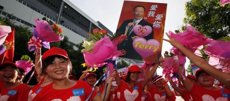 Foxconn workers hold a picture of Terry Gou, chairman of Foxconn Group, with Chinese characters reading, "Love Me, Love You," on during a rally to raise morale at the heavily regimented factories inside the Foxconn plant in Shenzhen, south China, Guangdong province, Wednesday August 18, 2010. (AP Photo/Kin Cheung)