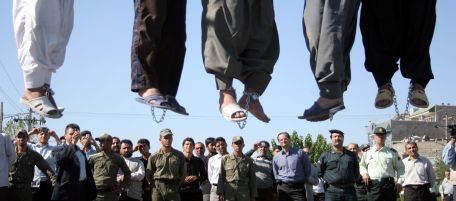 ** GRAPHIC CONTENT ** Iranian police officers and others view the scene as five convicted criminals are hung, in a neighborhood of Mashad, 1,000 kilometers (620 miles) northwest of Tehran, Iran, on Wednesday Aug. 1, 2007. In the second round of collective executions in ten days, Iran on Wednesday publicly hanged 7 criminals convicted on various charges of rape, robbery and kidnapping, according to reports on the official web-site of state broadcasting company. (AP Photo/Halabisaz)