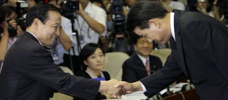 South Korea's new Prime Minister nominee Kim Tae-ho, right, bows to a chairman of hearing lawmaker Kim Kyung-jae, left, before a confirmation hearing in order to examine his qualification at the National Assembly in Seoul, South Korea, Tuesday, Aug. 24, 2010. (AP Photo/ Lee Jin-man)