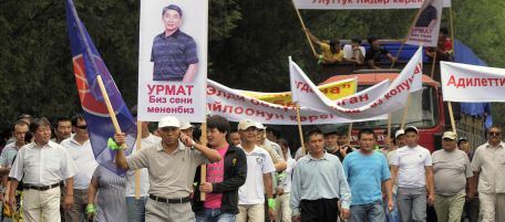 Supporters of former presidential hopeful Urmat Baryktabasov, seen on banner, rally to demand the resignation of the government, central Bishkek, Kyrgyzstan, Thursday, Aug. 5, 2010. Some 1,000 supporters of a former presidential hopeful rallied against Kyrgyzstan's interim government Thursday, raising fears of new instability in the turbulent Central Asian nation. (AP Photo/ Maxim Shubovich)