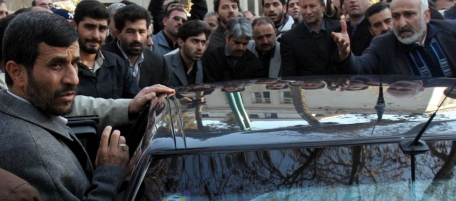 Iranian President Mahmoud Ahmadinejad, left, talk with his supporters as he attends a funeral ceremony for Iranian Justice Minister Jamal Karimi-Rad, in Tehran, Iran on Saturday Dec. 30, 2006. Karimi-Rad died on Thursday Dec. 28, 2006 in a car accident in Qom province 170 kms (102 miles) from Tehran.(AP Photo/Hasan Sarbakhshian)