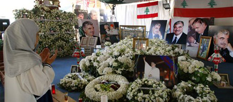 A girl prays in front of the tomb of Lebanon's slain former Prime Minister Rafik Hariri, seen in the pictures, in Martyr's Square in downtown Beirut, Saturday, May 14, 2005, three months after his death. Hariri's assassination on Feb. 14 united the country's fragmented society and political opposition and led to the withdrawal of Syrian troops from Lebanon. His son Saad Hariri has started his campaign to take his father's parliamentary seat in Lebanon's elections starting May 29. (AP Photo/Darko Vojinovic)