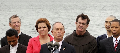 New York City Mayor Michael Bloomberg, center, City Council Speaker Christine Quinn, fourth from left, and members of local religious institutions stand in front of the Statue of Liberty for a news conference in New York, Tuesday, Aug. 3, 2010. The political and religious leaders were there to show their support for a mosque and Islamic cultural center planned in lower Manhattan. (AP Photo/Seth Wenig)