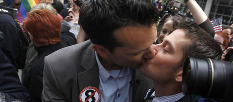 Spencer Jones, left, kisses his husband Tyler Barrick after hearing the decision in the United States District Court proceedings challenging Proposition 8 outside of the Phillip Burton Federal Building in San Francisco, Wednesday, Aug. 4, 2010. A federal judge overturned California's same-sex marriage ban in a landmark case that could eventually land before the U.S. Supreme Court to decide if gays have a constitutional right to marry in America, according to a person close to the case. (AP Photo/Jeff Chiu)