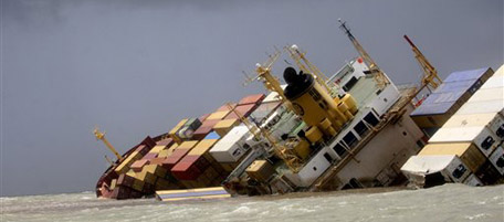 The Panamanian-registered container ship MSC Chitra that had Saturday collided with the MV-Khalijia-II, a St. Kitts registered ship, tilts in the Arabian Sea, close to Mumbai, India, Monday, Aug 9, 2010. Indian coast guard ships and helicopters are working to try and contain an oil spill from the dangerously tilting container ship following the collision near Mumbai, a spokesman for India's defense ministry said Monday.(AP Photo/Rafiq Maqbool)