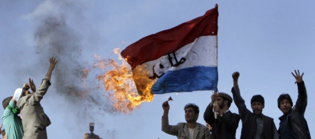 Afghan demonstrators burn the Dutch's flag during a demonstration against the reproduction of cartoons depicting the Prophet Muhammad in Danish newspapers and an upcoming Dutch film criticizing the Quran in Kabul, Afghanistan on Friday, March 21, 2008. Around 5,000 Afghans chanted slogans and burned Danish and Dutch flags Friday in the latest in a series of protests over perceived insults to Islam. (AP Photo/Musadeq Sadeq)