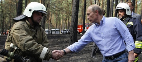Russian Prime Minister Vladimir Putin shakes hands with a fire fighter in a burned forest at Voronezh region on Wednesday, Aug. 4, 2010. Wildfires have wiped out Russian forests, villages and a military base sent the thickest blanket of smog yet over Moscow .(AP Photo/RIA Novosti, Alexei Nikolsky, pool)