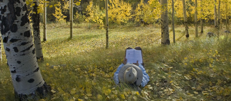 A person lays in the grass and fallen yellow aspen leaves while reading a book on a lazy day in the autumn near Buena Vista, Colo. on Tuesday, Sept. 29, 2009. (AP Photo/Nathan Bilow)