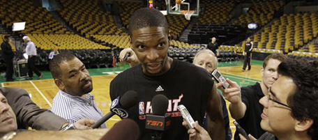 Miami Heat forward Chris Bosh talkes to members of the media at the end of a team shoot around before their season opening NBA basketball game against the Boston Celtics at the Garden in Boston, Tuesday afternoon, Oct. 26, 2010. (AP Photo/Stephan Savoia)