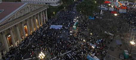 People gather at the Plaza de Mayo, next to the government palace, back in pink, in Buenos Aires, Argentina, to honor late Argentina's President Nestor Kirchner, Wednesday, Oct. 27, 2010. Kirchner, the husband of current Argentina President Cristina Fernandez, died Wednesday after suffering a heart attack. He was a likely candidate in next year's presidential elections.(AP Photo/Natacha Pisarenko)