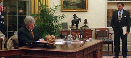 President Clinton vetos the second spending and borrowing bill Monday, Nov. 13, 1995 in the White House Oval Office as White House Chief of Staff Leon Panetta looks on. Clinton met with congressional leaders to explore ways of averting partial government shutdown late Monday night. Republican leaders requested the 11th hour talks with the president just an hour before the expiration at midnight Monday of most of the government's spending authority. (AP Photo/Dirk Halstead, POOL)