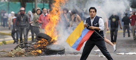 Supporters of Ecuador's President Rafael Correa protest against rebellious police outside the hospital where Ecuador's President Rafael Correa is located in Quito, Ecuador, Thursday Sept. 30, 2010. The government declared a state of siege Thursday after rebellious police, angered by a law that cuts their benefits, shut down airports and blocked highways in a nationwide strike. (AP Photo/Patricio Realpe)