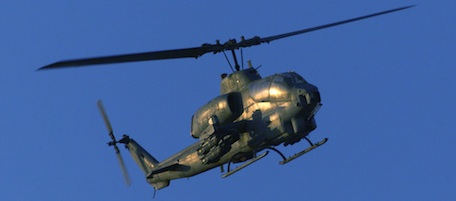 EDS NOTE: THIS PICTURE MAY HAVE BEEN REVIEWED AS IT WAS SENT VIA MILITARY COMMUNICATIONS-- A US Marine Cobra attack helicopter flies out from the US Marines operations base in southern Afghanistan late in the day Tuesday Dec. 4, 2001. (AP Photo/Jim Hollander/pool)