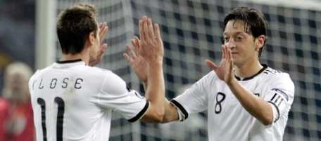 Germany's Mesut Oezil, right, celebrates scoring his side's 2nd goal with Germany's Miroslav Klose, left, during the Euro 2012 Group A qualifying soccer match between Germany and Turkey in Berlin, Germany, Friday, Oct 8, 2010. (AP Photo/Gero Breloer)