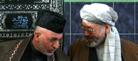 Afghan President Hamid Karzai, left, listens to his second vice president Abdul Karim Khalili during the Muharram procession at a main Shiite Muslim mosque in Kabul, Afghanistan , Monday, Jan. 29, 2007. Karzai renewed his call Monday for talks with the Taliban and other groups battling his government. "While we are fighting for our honor and dignity against an enemy who wants our destruction and wants us to bleed, once again we want to open a way for negotiations," Karzai told thousands gathered at the main Shiite Muslim mosque in Kabul. (AP Photo/Musadeq Sadeq)