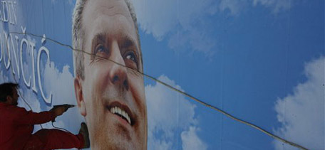 Bosnian worker fixes frame for a mega posters of political candidate Fahrudin Radoncic from the party of 'Union for better future', in Sarajevo, on Thursday, Sep. 30, 2010. National elections in Bosnia and Herzegovina are scheduled on Sunday Oct. 3, 2010, with a total of 39 parties and 11 coalitions registered to run for Bosnian tripartite Presidency and National Assembly this year.(AP Photo/Amel Emric)