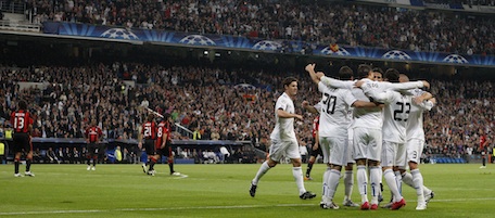 Real Madrid's Mesut Ozil from Germany, second right, celebrates after scoring with team mates during his Group G Champions League soccer match against AC Milan at the Santiago Bernabeu stadium, in Madrid Tuesday Oct. 19, 2010. (AP Photo/Andres Kudacki)