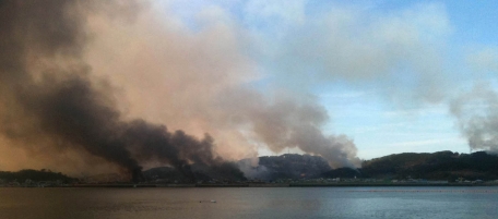 This picture taken on November 23, 2010 by a South Korean tourist shows huge plumes of smoke rising from Yeonpyeong island in the disputed waters of the Yellow Sea on November 23, 2010. North Korea fired dozens of artillery shells onto a South Korean island on November 23, 2010, killing two people, setting homes ablaze and triggering an exchange of fire as the South's military went on top alert. REPUBLIC OF KOREA OUT AFP PHOTO (Photo credit should read STR/AFP/Getty Images)