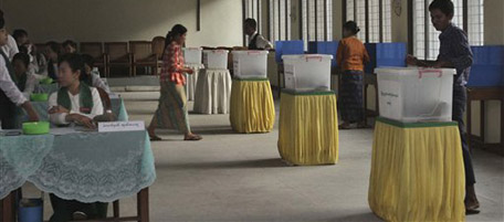 In this photo taken during a poll monitoring tour for Myanmar journalists and foreign diplomats, Myanmar voters cast their ballots at a polling center in Yangon, Myanmar, Sunday, Nov. 7, 2010. (AP Photo/Khin Maung Win)