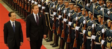 British Prime Minister David Cameron, second from left, is escorted by Chinese Premier Wen Jiabao as they inspect the honor guards during a welcoming ceremony at the Great Hall of the People in Beijing, China Tuesday, Nov. 9, 2010. Cameron arrived in Beijing on Tuesday, leading his country's largest-ever official delegation to China in the latest European push to win business and spur a sluggish economy at home. (AP Photo/Andy Wong)