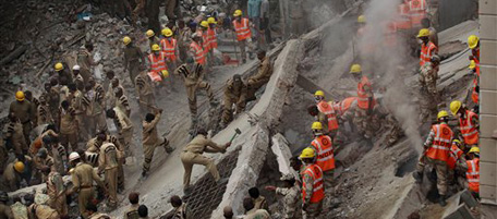 Indian rescue workers break concrete to search for bodies amid debris after a four-story apartment building collapsed in New Delhi, India, Tuesday, Nov.16, 2010. Dozens of residents were killed and scores injured when the 15-year-old building housing about 200 people collapsed late Monday night, police reports said. (AP Photo/Kevin Frayer)