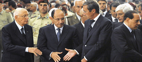 In this photo released by The Italian Presidency Press Office, Italian Premier Silvio Berlusconi, second right, shakes hands with Constitutional court president Francesco Amirante, right, during the state funerals of the victims of an attack on an Italian military convoy in Kabul on Thursday Sept. 17, in the St. Paul's Outside the Walls Basilica, in Rome, Monday Sept. 21, 2009. At left, President Giorgio Napolitano, shakes hands with Lower Chamber President Gianfranco Fini, center, and Senate speaker Renato Schifani. (AP Photo/Italian Presidency Press Office, HO) ** EDITORIAL USE ONLY **