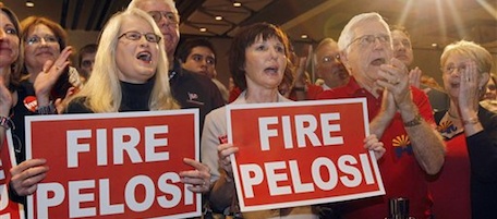 Holding signs reading "FIRE PELOSI," Tammy Tideman, left, of Mesa, Ariz., and Carla Schwarte, center, of Phoenix, join hundreds of supporters as they cheer Sen. John McCain, R-Ariz., as he walks on stage with his family, Tuesday, Nov. 2, 2010, at a Republican election night party in Phoenix. (AP Photo/Ross D. Franklin)