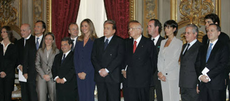 The new Italian ministers of Premier Silvio Berlusconi's 62nd postwar government, pose for a photo with Italian President Giorgio Napolitano, at center-right with gray suit and red tie, after taking their oath of office, in Rome's Quirinale presidential palace, Thursday May 8, 2008. From left foreground: University and Research minister, Mariastella Gelmini; Culture minister Sandro Bondi; Foreign Affairs minister Franco Frattini; Youth Policies minister Giorgia Meloni; Implementation of Government Program minister Gianfranco Rotondi (in background); Public Functions and Innovation minister Renato Brunetta (in foreground between women;) Environment minister Stefania Prestigiacomo (in dark purple suit foreground;) Premier Silvio Berlusconi; Italian President Giorgio Napolitano; Agriculture minister Luca Zaia (behind Napolitano;) Equal Opportunities minister Mara Carfagna; Industry minister Claudio Scajola; Regional Affairs minister Raffaele Fitto in background, Relations with Parliament minister Elio Vito, Berlusconi was sworn in as premier Thursday, his third time as head of an Italian government, following his conservatives' sweep in elections last month. (AP Photo/Luca Bruno)