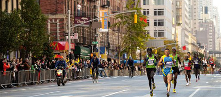 The elite men's division runs up First Ave. in the Manhattan borough of New York during the New York City Marathon, Sunday Nov. 7, 2010 in New York. Gebre Gebrmariam of Ethiopia, running third in the green singlet won the race with a time of 02:08:14. (AP Photo/Stephen Chernin)